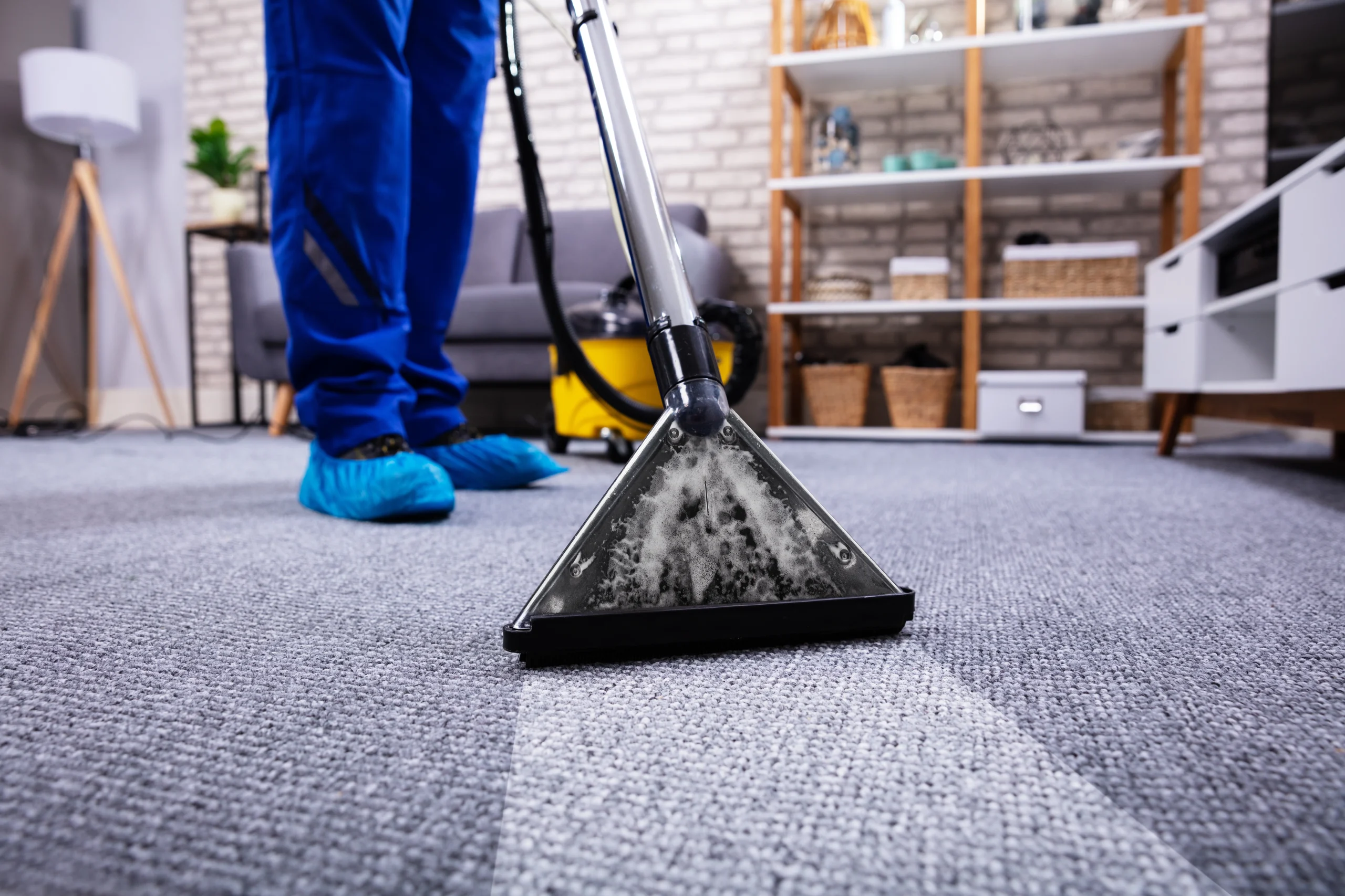 a cleaner vacuuming a carpet for end of tenancy cleaning London