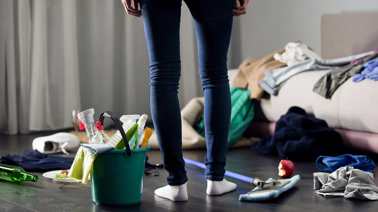 a person standing in a messy room before end of tenancy cleaning London